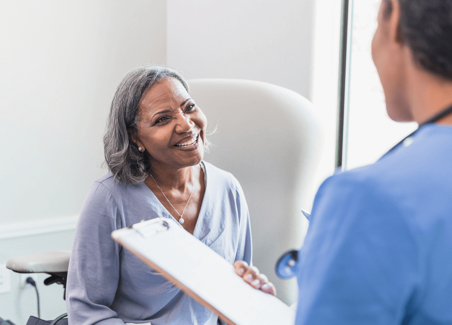 happy patient talking to her physician