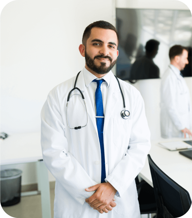 a male physician smiling at his office